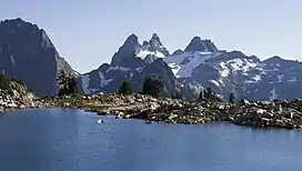 The double summit Chimney Rock centered with Overcoat Peak to right. Lower Tank Lake in foreground.