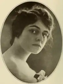 A young white woman with dark hair, in an oval frame