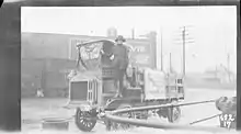 Luella Bates standing next to her FWD Model B truck.