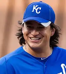 A man in a blue baseball uniform and hat