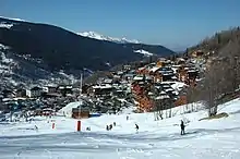 Winter panorama including the village skyline, surrounding mountains and ski hills