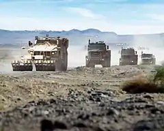 In convoy, an M-ATV with mine roller attachment) and two MTVRs with TerraMax. The third MTVR is manned.