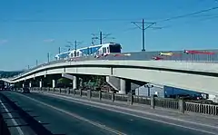 A MAX train traveling across a long viaduct