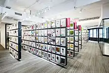 An angled view of materials hung on the panels of a material library curated by Material ConneXion (MCX) in New York City.