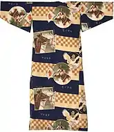 Back view of a child's kimono with short sleeves and pictures of horses, dogs and pigeons on a background of blue stripes and orange-cream checkers.