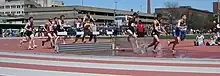 Image 21Men traversing the water jump in a steeplechase competition (from Track and field)