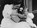 Mabel Grosvenor explores the contents of a box with her grandmother, Mabel Hubbard Bell on the steps of their summer home in Baddeck Nova Scotia.