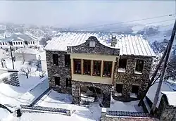 Three-storey stone-building in a snowy area