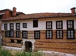 Brown-and-white building with two rows of windows