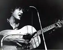 Passionate-looking young man playing guitar