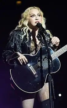 Madonna standing in front of a microphone