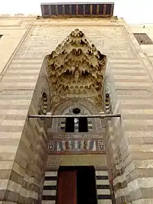 Pyramidal muqarnas canopy, along with ablaq, marble mosaic, and carved stone decoration, in the portal of the Madrasa of Umm al-Sultan Shaban (1368)