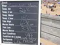 Board with daily conditions at main entrance to beach