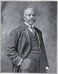 A black and white photograph of a man in a suit