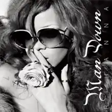 A black and white image of Rihanna wearing oversized sunglasses with "Man Down" written vertically on the right hand side