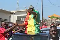 A protester draped in Guinea flag