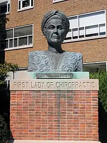 The bronze bust of Mabel Heath Palmer in Heritage Courtyard on the Davenport Campus of Palmer College of Chiropractic.
