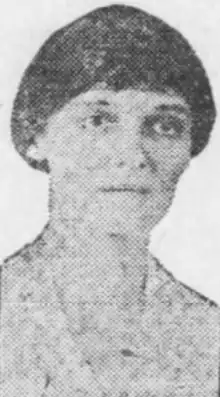 A newspaper photo of a white woman. Her hair is either short or dressed up from her nape.