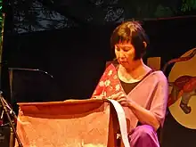 Tan performing on toy piano in 2015