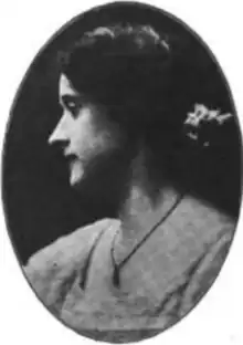 A white woman with dark hair, in profile, in an oval frame