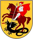 A coat of arms depicting a man in full body armour riding a brown horse that is trampling a black dragon all on a yellow background