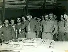 Austin R. Brunelli cutting the cake with the members of the 24th Marine Regiment during the celebration of the Marine Corps Birthday in Maui, 1944.