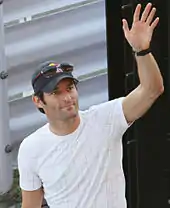 Mark Webber waving to the crowd with his left hand