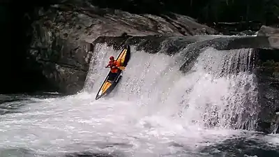 A whitewater canoeist running Baby Falls on the Tellico River.