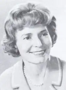 A smiling middle-aged white woman with coiffed hair
