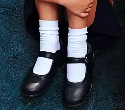 Modern Mary Jane school shoes worn with socks. Usually worn by primary school-aged girls, even in the 21st century.