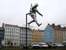 Sculpture called the Mauerspringer (Wall jumper) marking the spot at  the corner of Ruppiner Straße and Bernauer Straße where the historic defection of East German soldier Conrad Schumann took place where he jumped over the barbed wire marking the border between East and West Berlin on 15 August 1961.