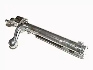 A Mauser 98 bolt showing two locking lugs just behind the face of the bolt. There is a third "emergency" lug in front of the bolt handle, in case the primary ones fail under pressure. In some designs the bolt handle itself may serve as the emergency "lug".