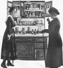Old drawing of two woman admiring a kitchen cabinet