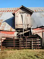 The gabled dormer on the barn near collapse prior to restoration