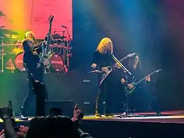 A four-piece band performing onstage