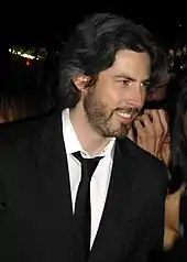 A profile image of Jason Reitman. A young, caucasian male with shoulder-length dark hair. He is seen from his right, smiling towards something off camera.