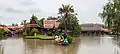 Traditional Thai wooden houses and two Thai childs' dolls at Ayothaya floating market, another renowned  floating market in Thailand