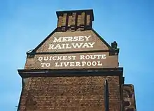 Original Mersey Railway painted sign on Birkenhead Central station, the company's former headquarters.