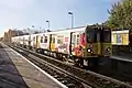 A Merseyrail Class 507 waits at the station.