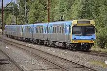 An old train (comeng) travelling along tracks in McKinnon