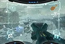 A video game screenshot. A weapon points outwards towards a snowy landscape.