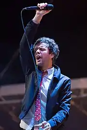 Michael Angelakos performing in 2015
