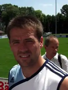 A man wearing a sleeveless football training shirt