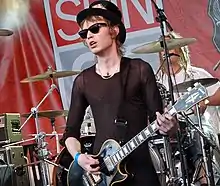 Larkin performing with Hole in 2010.