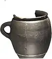 Tankard Black burnished-ware tankard, thought to have been made in either Dorset, the Thames estuary or Kent between 120-200AD. It has been polished with small stones to give it a grey-black metallic sheen.