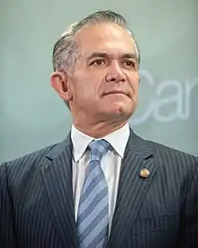 Miguel Ángel Mancera stands in front of a wall.