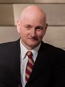 Mike Nickel wearing suit and tie, looking right of camera