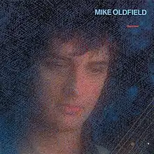 A blue mottled image of Oldfield's face and a portion of a guitar neck. The words Mike Oldfield Discovery are to the top right of the image.