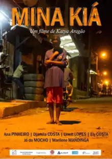 Movie poster; a young black woman walking down an unpaved city street, her eyes downcast. It is night, the street is lit with orange light.
