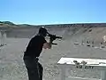 Mini Uzi being fired with magazines held together horizontally.